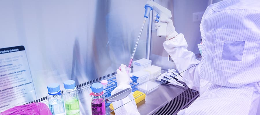 A cell & gene therapy scientist in a manufacturing cleanroom facility.