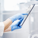 Pharma contract manufacturing professional using a tablet.