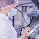 Pharma manufacturing professional working on a deviation using a digital QMS