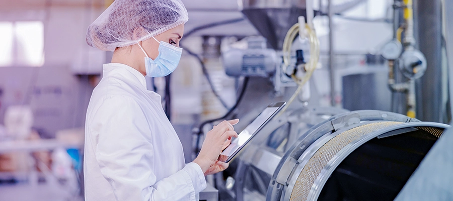 Pharma manufacturing professional working on a deviation using a digital QMS